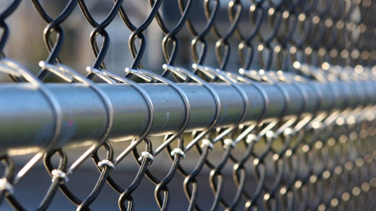 Silver galvanized chain link fence with a steel top rail in Montgomery County